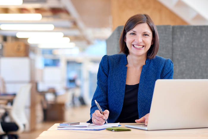 woman in blazer with computer